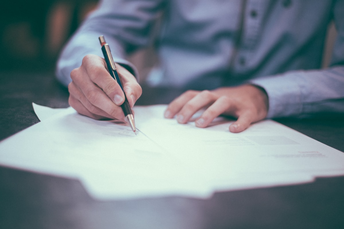 Two people reviewing UK car finance paperwork — guarantor arrangements involve shared responsibility and formal credit checks